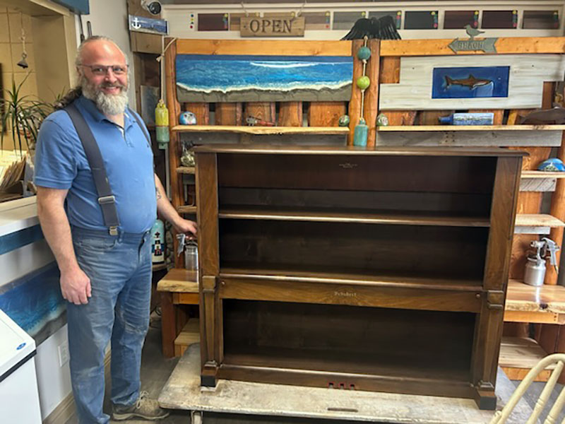 Rick standing by a cabinet